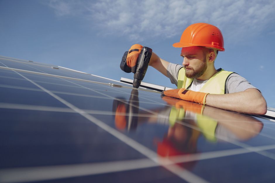 Professional solar installation crew working on a residential roof